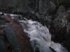 Looking down at the dim chute below