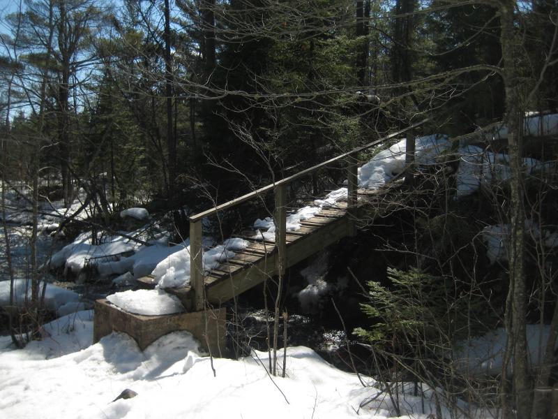 A slanted wooden bridge down to the river