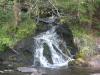 Foaming waterfall from across the river