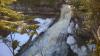 Gushing falls over the fanning rock