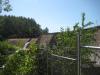 Larger dam and small distant falls