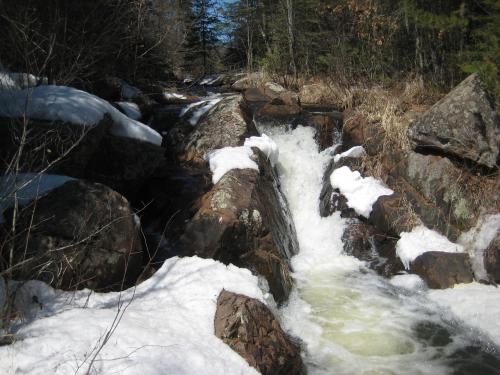 Small drop between snowy rocks