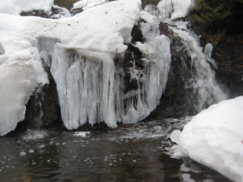 Icicles hanging off the rocks near the falls