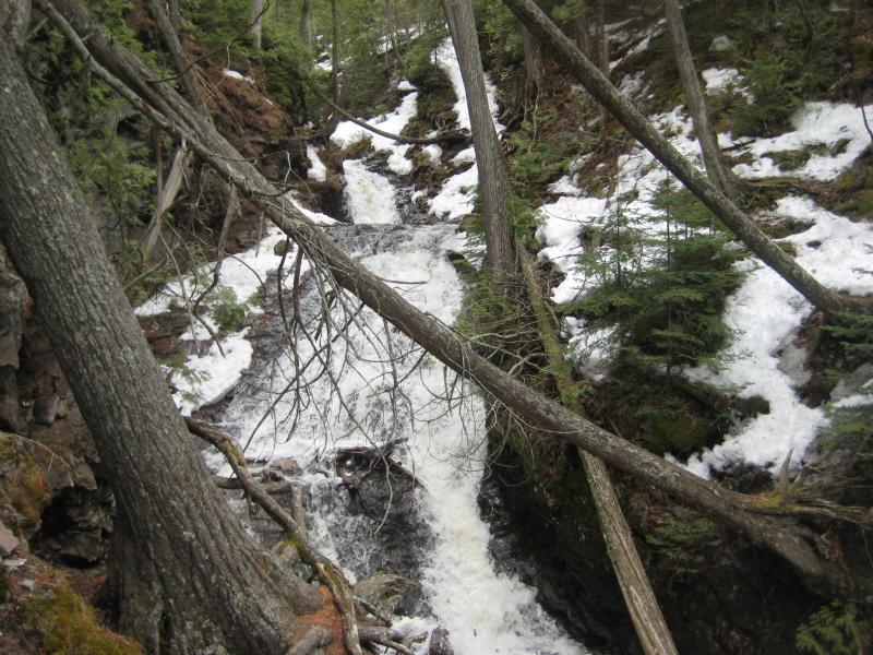 Icy chain of drops with draping logs