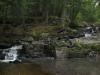 Blocky rocks pushing the water over