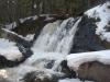 Flowing curtain of water over the rocks