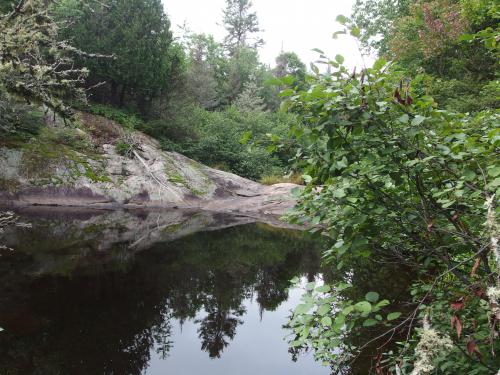 Dry outcropping above the pool