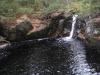 Tiny chute emptying into a deep pool