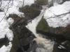 Small chute between snowy boulders