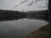 Dark lake under grey clouds