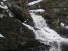 Cascades down mossy shelves of rock