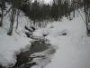 Calm waters between snowy banks