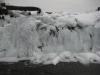 Little splashes of water seeping through the wooden dam