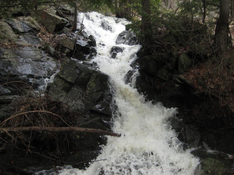 Angry foaming waters over black rocks