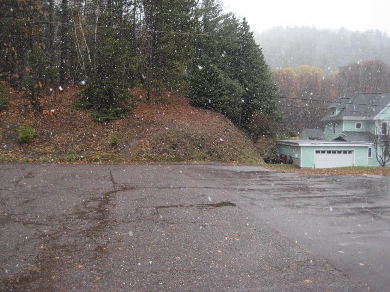 Falling snow over the parking lot