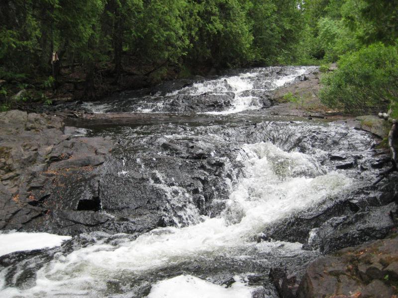 A lower, blocky waterfall
