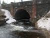 Some snow around the sandstone bridge