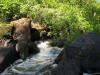 Small drop surrounded by big rocks