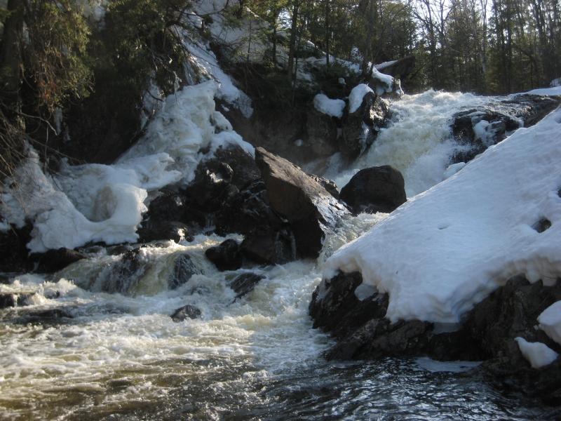 Snow covered rocks around the falls