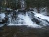 Dark, snowy waterfall