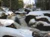 Snow covering rocks and water