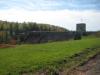 Looking back at the dam beyond the grassy flat