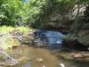 Overhanging rock wall above a drop