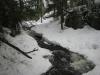 Creek bubbling up through the snowy surface