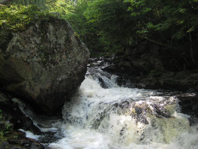 Huge boulder perched on falls