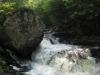 Huge boulder perched on falls